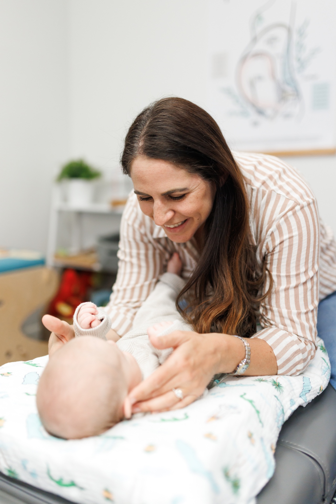 Dr. Alli Parisi providing pediatric chiropractic care to an infant